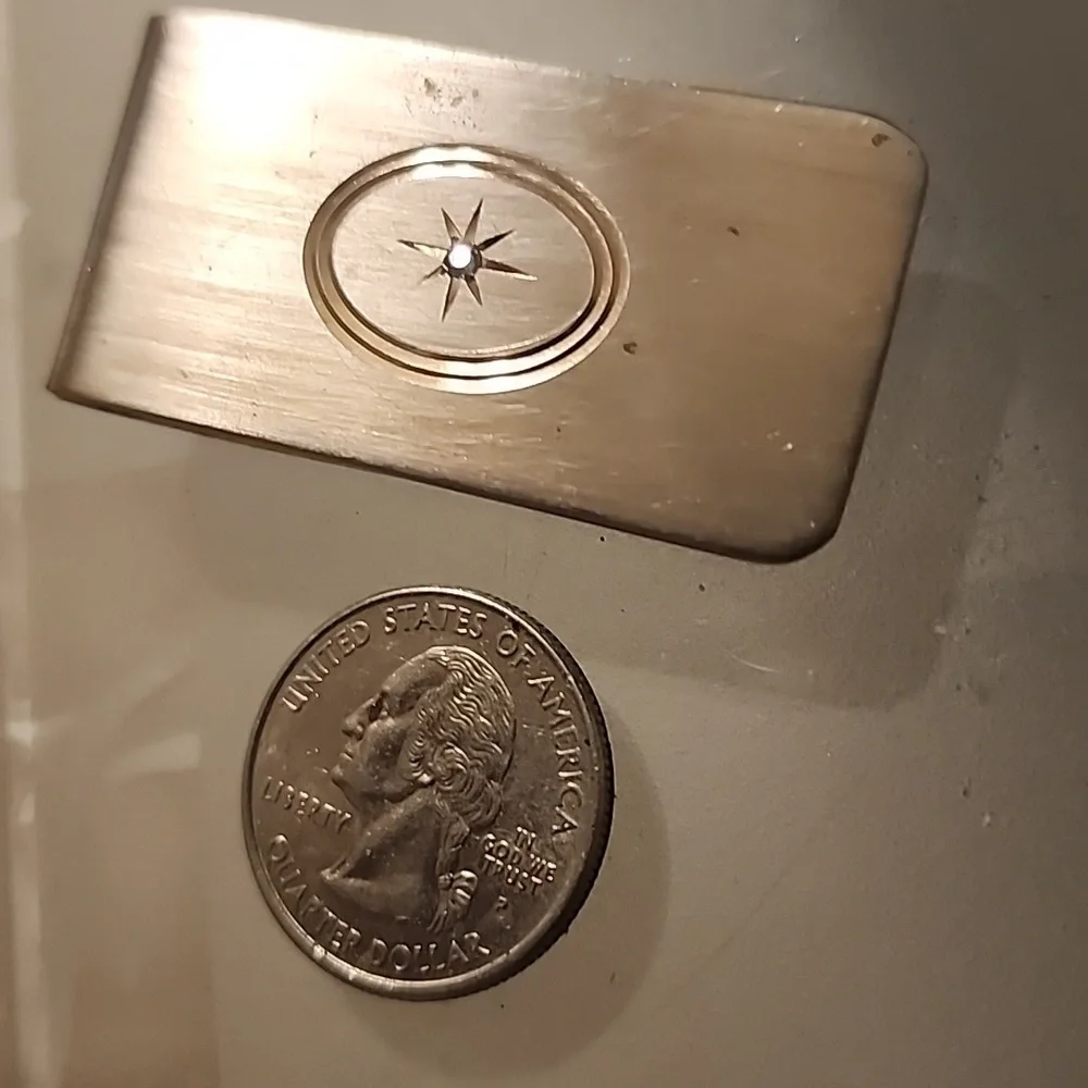 Goldtone  Money Clip With A Diamond Like Stone.